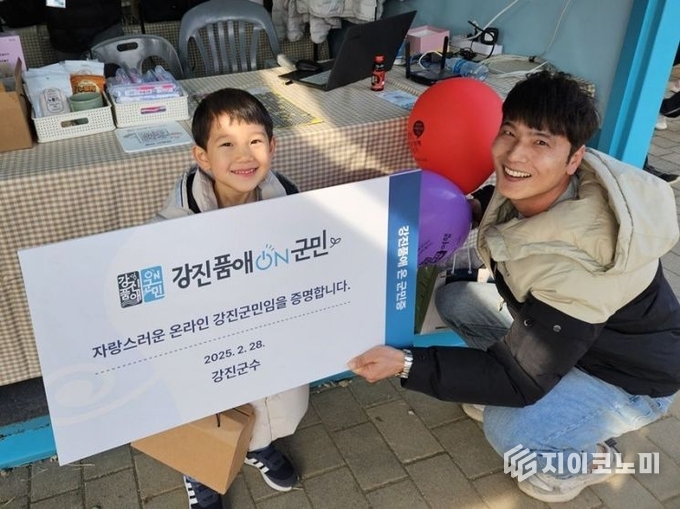 강진 청자축제장 부스에서 가입한 신규 회원이 강진품애 온 군민증을 들고 있다. 강진군 제공