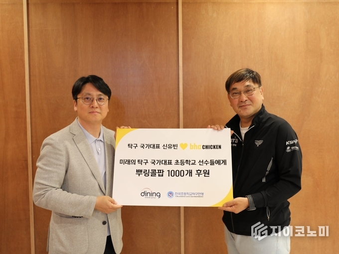 bhc가 ‘뿌링클’ 모델이자 대한민국 탁구 국가대표인 신유빈 선수의 국제대회 우승을 기념해, 초등학교 탁구 유망주들에게 ‘뿌링콜팝’ 1,000개를 기부하는 뜻깊은 나눔을 실천했다.(▲ 박원철 다이닝브랜즈그룹 홍보담당 이사(왼쪽)와 서민성 한국초등학교탁구연맹 실무부회장). /사진=BHC