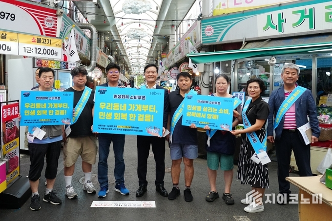 28일 돈암전통시장을 찾은 이승로 성북구청장(네번째)이 상인, 성북구 직원과 함께 지역 안에서 소비쿠폰 신속 사용을 독려하는 캠페인을 펼치고 있다.