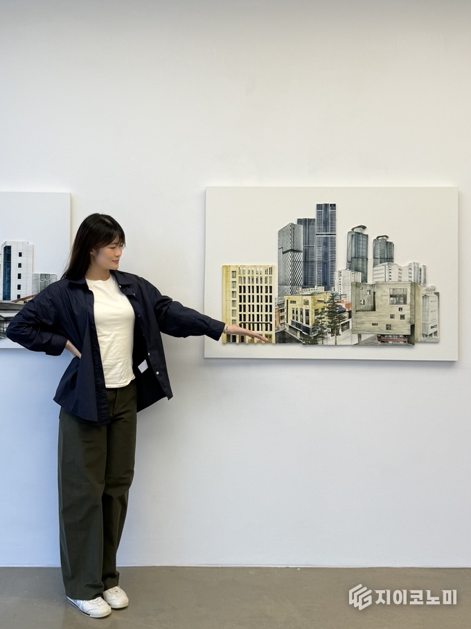 '뚝섬에서 본 풍경' 도자기 백자페이퍼클레이, 고화도안료, 산화소성/1170x800mm/ 2025 를 설명하고 있는 김수아 작가